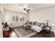 Cozy living room with a comfortable couch, ceiling fan, plantation shutters, and a stylish area rug at 690 W 172Nd Pl, Broomfield, CO 80023
