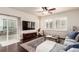 Bright living room with a comfortable couch, sliding glass door to the backyard, and plantation shutters at 690 W 172Nd Pl, Broomfield, CO 80023
