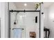 Modern tiled shower featuring sleek, black fixtures, a glass door, and tasteful decorations at 690 W 172Nd Pl, Broomfield, CO 80023