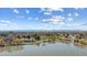 Picturesque aerial view of community with lake, park, and stunning mountain views at 1299 S Dale Ct, Denver, CO 80219
