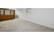 Finished basement area with new carpet and access to the stairs at 1299 S Dale Ct, Denver, CO 80219