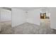 Finished basement area with new carpet and an archway view at 1299 S Dale Ct, Denver, CO 80219