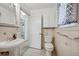 Bright bathroom featuring a pedestal sink, tiled walls, and patterned floors at 1299 S Dale Ct, Denver, CO 80219