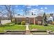 Charming brick home featuring a well-maintained lawn and inviting front entrance at 1299 S Dale Ct, Denver, CO 80219