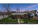Charming brick home featuring a well-maintained lawn and inviting front entrance at twilight at 1299 S Dale Ct, Denver, CO 80219