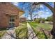 Charming brick home with a sidewalk, lush lawn, and mature tree at 1299 S Dale Ct, Denver, CO 80219