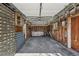 Unfinished garage interior: exposed studs and outdated cabinets offer renovation potential at 1299 S Dale Ct, Denver, CO 80219