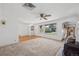 Bright living room with large windows, neutral carpet, and an archway at 1299 S Dale Ct, Denver, CO 80219