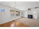 Bright living room featuring an elegant chandelier, and a rustic fireplace at 1299 S Dale Ct, Denver, CO 80219