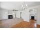 Spacious living room featuring hardwood floors, a chandelier, and a fireplace at 1299 S Dale Ct, Denver, CO 80219