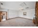 Expansive living room boasting neutral carpet, natural light, wood trim, and built-in shelving at 1299 S Dale Ct, Denver, CO 80219