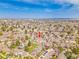 Wide aerial view showcases the home's location in a residential community with ample greenery and convenient city access at 9658 W Chatfield Ave # D, Littleton, CO 80128