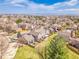 Beautiful aerial shot showcases well-maintained homes in a neighborhood surrounded by trees, greenery, and a stunning vista at 9658 W Chatfield Ave # D, Littleton, CO 80128