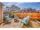 Charming backyard patio featuring stone pavers, stylish seating, and wood fence for private relaxation and outdoor enjoyment at 9658 W Chatfield Ave # D, Littleton, CO 80128
