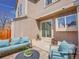 Serene patio with stylish seating, a sliding door, and space for plants, seamlessly blending indoor-outdoor living at 9658 W Chatfield Ave # D, Littleton, CO 80128