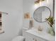 Elegant powder room featuring modern vanity, faucet, and decorative mirror at 9658 W Chatfield Ave # D, Littleton, CO 80128