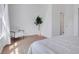 Light and airy bedroom with modern chair and hardwood floors at 9658 W Chatfield Ave # D, Littleton, CO 80128