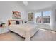Bright bedroom featuring a queen-sized bed with two large windows letting in lots of natural light at 9658 W Chatfield Ave # D, Littleton, CO 80128