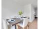 Dining area features a dark wood table set for four with light-colored chairs at 9658 W Chatfield Ave # D, Littleton, CO 80128