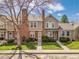 Charming townhome with brick accents, a well-manicured lawn, and mature trees at 9658 W Chatfield Ave # D, Littleton, CO 80128