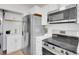 Modern kitchen with stainless steel appliances, white cabinets, and granite countertops, creating a stylish and functional space at 9658 W Chatfield Ave # D, Littleton, CO 80128