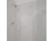 Bathroom shower with sleek marble tile and modern fixtures at 9658 W Chatfield Ave # D, Littleton, CO 80128
