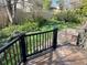 Landscaped backyard with deck and surrounding lush greenery, offering a serene outdoor space at 12452 W Dumbarton Pl, Morrison, CO 80465