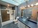 Stylish bathroom boasts modern fixtures, a glass bowl sink, and shower with glass door at 12452 W Dumbarton Pl, Morrison, CO 80465