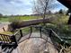 A beautiful wood deck features black metal railings, complemented by a view of the green landscape beyond at 12452 W Dumbarton Pl, Morrison, CO 80465
