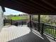 A spacious covered patio features a wooden deck with scenic views and black metal railings at 12452 W Dumbarton Pl, Morrison, CO 80465
