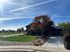 Two-story house with a well-maintained lawn, driveway and lush landscaping with mature trees at 12452 W Dumbarton Pl, Morrison, CO 80465