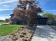 Charming home with well-manicured lawn and mature tree, with a driveway leading to an attached garage at 12452 W Dumbarton Pl, Morrison, CO 80465