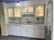 The Kitchen features white cabinets, tile backsplash, farmhouse sink and updated appliances at 12452 W Dumbarton Pl, Morrison, CO 80465