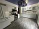 Updated kitchen featuring white cabinets, stainless steel appliances, and modern countertops at 12452 W Dumbarton Pl, Morrison, CO 80465