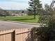 Picturesque neighborhood view with green space and a glimpse of the city skyline in the distance at 12452 W Dumbarton Pl, Morrison, CO 80465