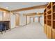 Expansive basement with exposed beams, built-in shelves, a wet bar and neutral carpeting at 9025 Jellison Ct, Broomfield, CO 80021