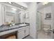 Bright bathroom featuring a vanity with a gray countertop and a shower with glass doors at 9025 Jellison Ct, Broomfield, CO 80021