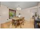 Dining room with wood floors, decorative chandelier, and a bright view to the outdoors at 9025 Jellison Ct, Broomfield, CO 80021