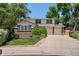 Charming two-story home with a well-manicured lawn, mature trees, and a two-car garage at 9025 Jellison Ct, Broomfield, CO 80021