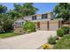 Charming two-story home with a well-manicured lawn, mature trees, and a two-car garage at 9025 Jellison Ct, Broomfield, CO 80021