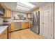 Bright kitchen with stainless steel appliances, wood cabinets, and hardwood floors at 9025 Jellison Ct, Broomfield, CO 80021
