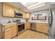 Well-lit kitchen featuring stainless appliances, wood cabinets and a spacious countertop at 9025 Jellison Ct, Broomfield, CO 80021