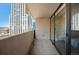 Condo balcony with sliding glass doors and concrete railing overlooking city buildings at 1020 15Th St # 20N, Denver, CO 80202