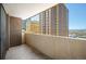 Condo balcony featuring views of Denver cityscape, brick accent wall, and concrete railing at 1020 15Th St # 20N, Denver, CO 80202