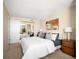 Comfortable bedroom featuring plush bed, mirrored closet doors and neutral color palette at 1020 15Th St # 20N, Denver, CO 80202