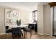 Stylish dining area featuring a modern table setting, hardwood floors, and contemporary artwork at 1020 15Th St # 20N, Denver, CO 80202