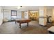 Well-lit game room with a pool table, lounge seating, and an adjacent dining area with an attractive carpet pattern at 1020 15Th St # 20N, Denver, CO 80202