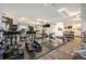 Well-equipped gym with modern cardio machines, weightlifting equipment, mirrored walls, and 