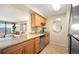 Modern kitchen featuring granite countertops, wooden cabinetry, and a view to the living room at 1020 15Th St # 20N, Denver, CO 80202