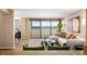 Bright living room featuring hardwood floors, balcony access with city views, and stylish decor at 1020 15Th St # 20N, Denver, CO 80202